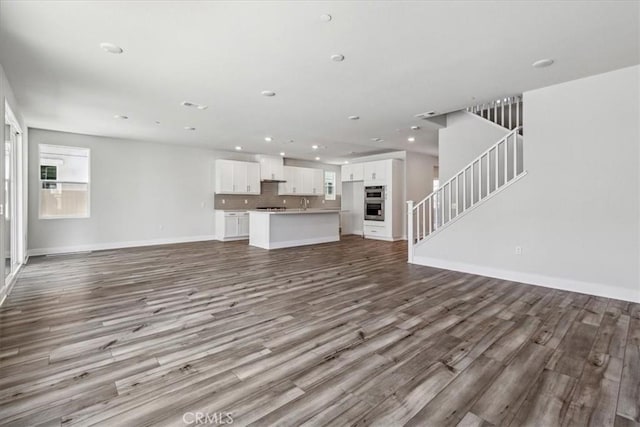 16669 Dara Ave, Chino, CA 91708 - unfurnished living room with wood finished floors, stairs, and recessed lighting