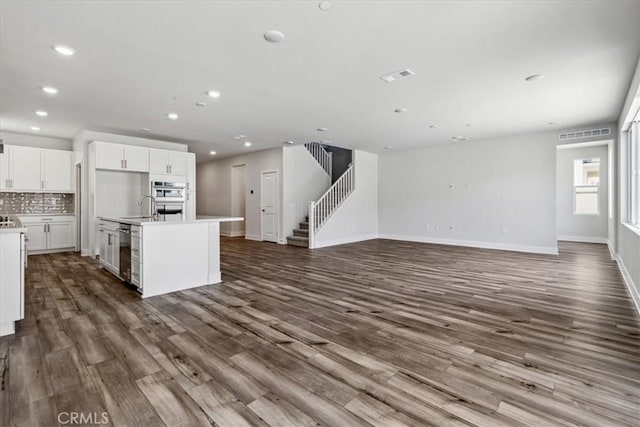 16669 Dara Ave, Chino, CA 91708 - kitchen featuring open floor plan, appliances with stainless steel finishes, dark wood-type flooring, a center island with sink, and recessed lighting