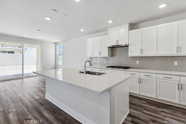 16669 Dara Ave, Chino, CA 91708 - kitchen with dark wood-style floors, gas stovetop, a center island with sink, decorative backsplash, and recessed lighting