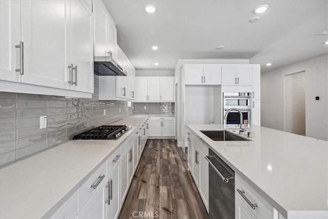 16669 Dara Ave, Chino, CA 91708 - kitchen with appliances with stainless steel finishes, exhaust hood, recessed lighting, dark wood-style floors, and light countertops