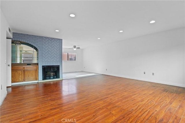 21900 Roscoe Blvd Unit 5, Canoga Park, CA 91304 - unfurnished living room with a fireplace, wood finished floors, ceiling fan, and recessed lighting