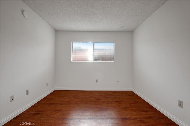 21900 Roscoe Blvd Unit 5, Canoga Park, CA 91304 - unfurnished room with wood finished floors, a textured ceiling, and baseboards