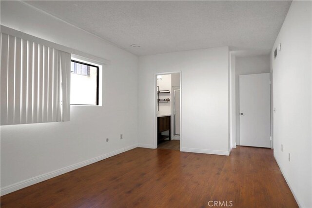 21900 Roscoe Blvd Unit 5, Canoga Park, CA 91304 - unfurnished bedroom with baseboards, wood finished floors, and visible vents