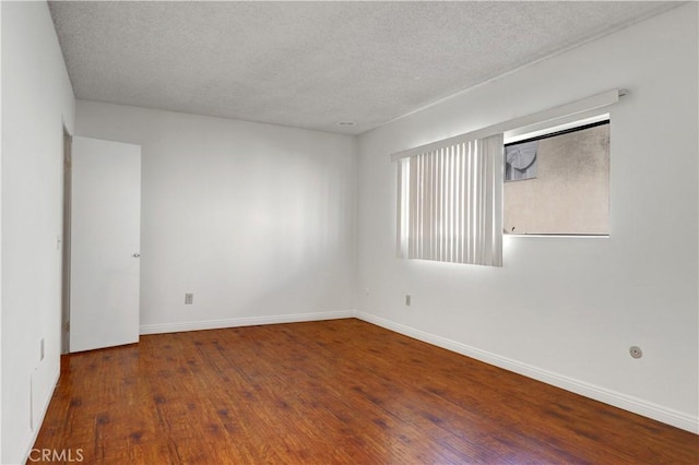 21900 Roscoe Blvd Unit 5, Canoga Park, CA 91304 - unfurnished room featuring baseboards, wood finished floors, and a textured ceiling