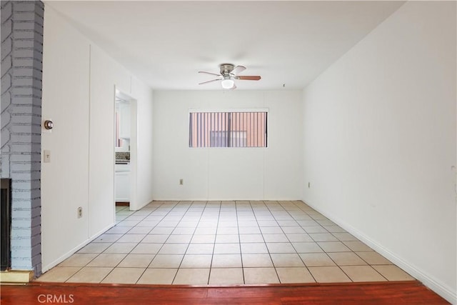 21900 Roscoe Blvd Unit 5, Canoga Park, CA 91304 - unfurnished room featuring a ceiling fan, a brick fireplace, and light tile patterned floors