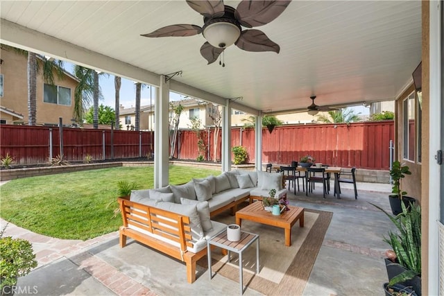 view of patio with a fenced backyard, ceiling fan, an outdoor hangout area, and outdoor dining space