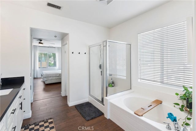 bathroom featuring a shower stall, visible vents, vanity, a bath, and ensuite bath