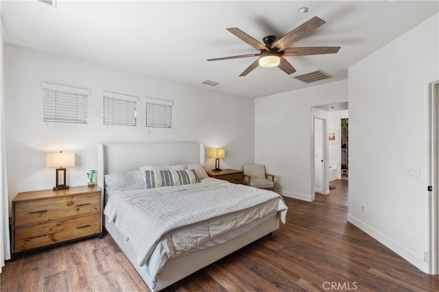 bedroom with baseboards, wood finished floors, and visible vents
