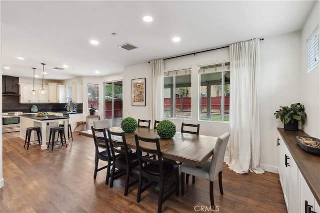 dining room featuring dark wood-style flooring, visible vents, recessed lighting, and a healthy amount of sunlight