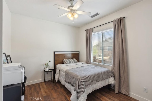 bedroom featuring baseboards, a ceiling fan, wood finished floors, and visible vents