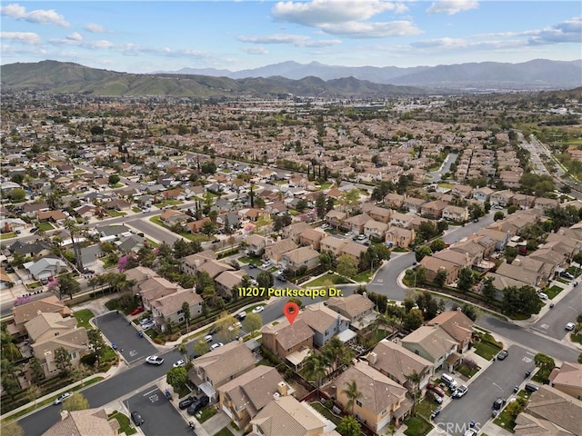 drone / aerial view featuring a residential view and a mountain view