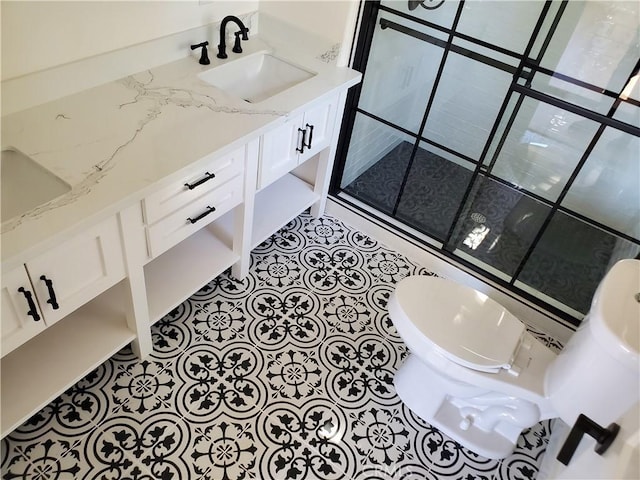 full bath with tile patterned flooring, toilet, and a sink