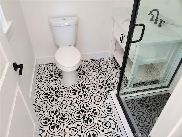 bathroom featuring tile patterned floors, baseboards, and toilet