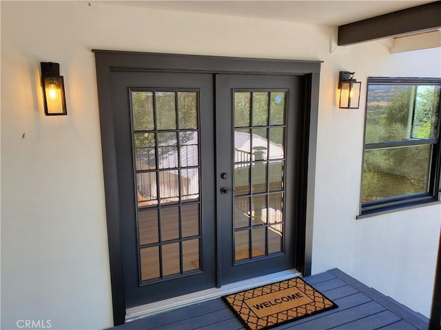 entrance to property with stucco siding and french doors