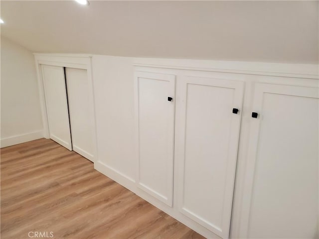 room details with wood finished floors, recessed lighting, and a decorative wall