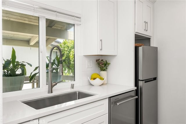 23732 Hillhurst Dr Unit 32, Laguna Niguel, CA 92677 - kitchen with white cabinetry, stainless steel appliances, light countertops, and a sink