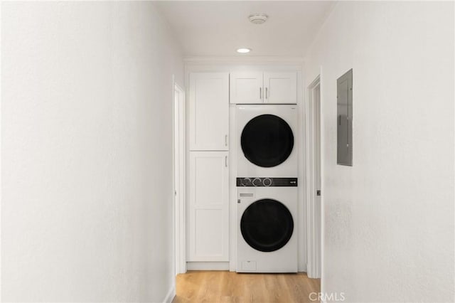 23732 Hillhurst Dr Unit 32, Laguna Niguel, CA 92677 - clothes washing area with electric panel, light wood-type flooring, cabinet space, stacked washer and clothes dryer, and recessed lighting