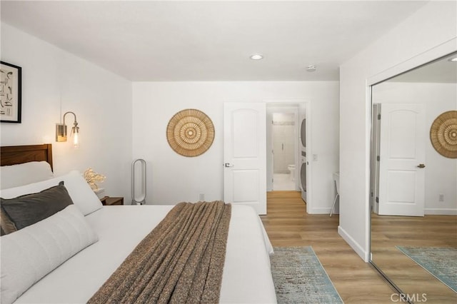 23732 Hillhurst Dr Unit 32, Laguna Niguel, CA 92677 - bedroom featuring baseboards, stacked washing maching and dryer, light wood finished floors, and recessed lighting