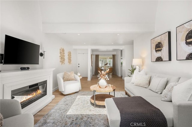 23732 Hillhurst Dr Unit 32, Laguna Niguel, CA 92677 - living room featuring light wood-type flooring, baseboards, a glass covered fireplace, recessed lighting, and beamed ceiling