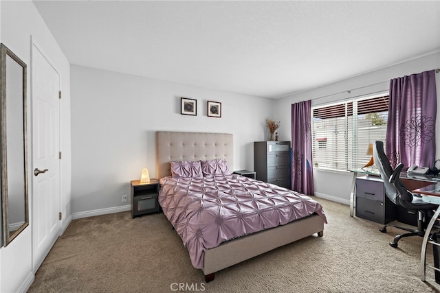bedroom featuring carpet and baseboards