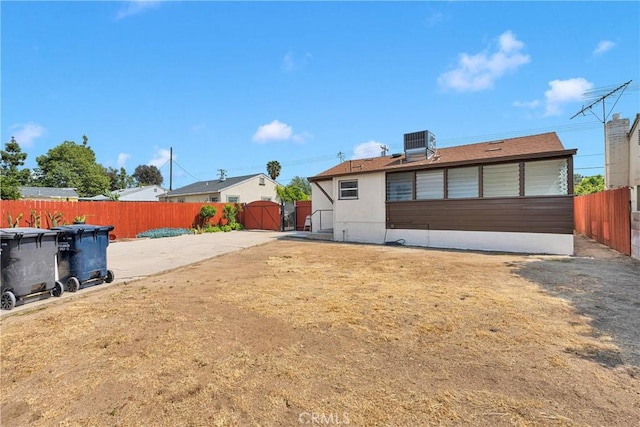312 W Lugonia Ave, Redlands, CA 92374 - rear view of property featuring central air condition unit and fence