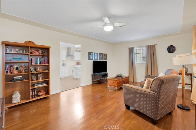 312 W Lugonia Ave, Redlands, CA 92374 - living area with a ceiling fan, light wood-style flooring, and baseboards