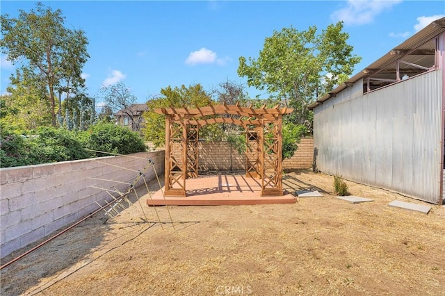 312 W Lugonia Ave, Redlands, CA 92374 - fenced backyard featuring a wooden deck and a pergola
