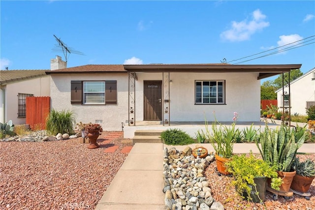 312 W Lugonia Ave, Redlands, CA 92374 - view of front of house featuring stucco siding, fence, and a chimney