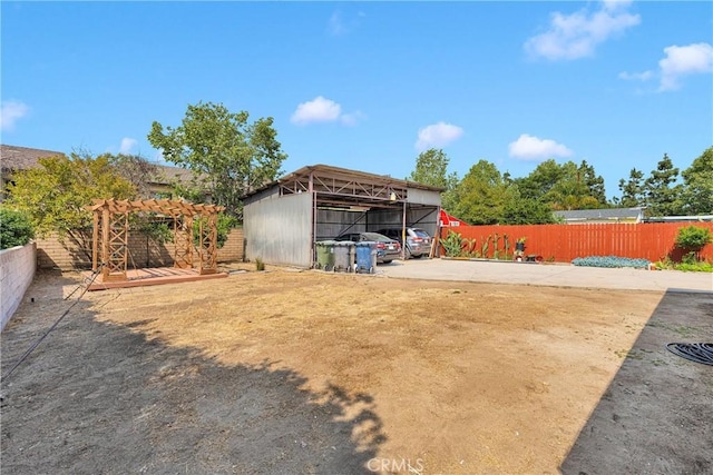 312 W Lugonia Ave, Redlands, CA 92374 - view of yard featuring fence, a detached carport, and a pergola