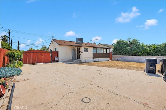312 W Lugonia Ave, Redlands, CA 92374 - back of property with a gate, fence, stucco siding, and central AC unit