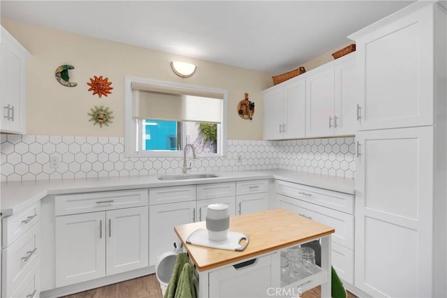 312 W Lugonia Ave, Redlands, CA 92374 - kitchen with a sink, light countertops, white cabinets, and backsplash