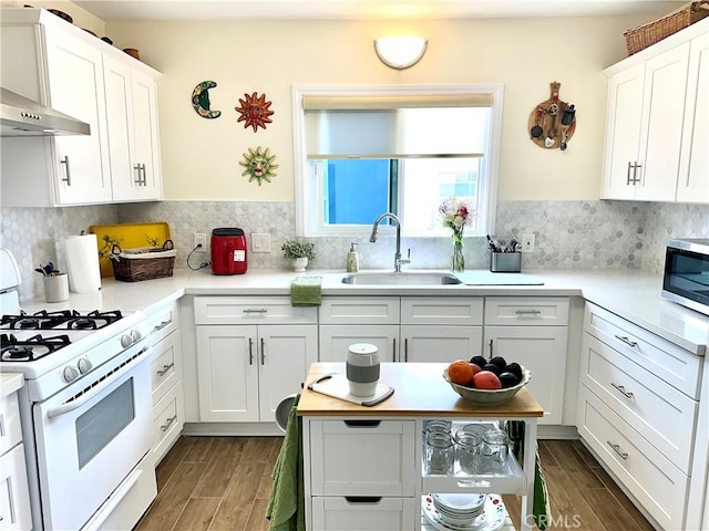312 W Lugonia Ave, Redlands, CA 92374 - kitchen with gas range gas stove, a sink, stainless steel microwave, and dark wood-style flooring