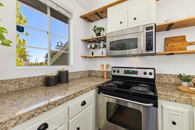20371 Bluffside Cir Unit B401, Huntington Beach, CA 92646 - kitchen featuring tile countertops, a wealth of natural light, open shelves, and stainless steel appliances