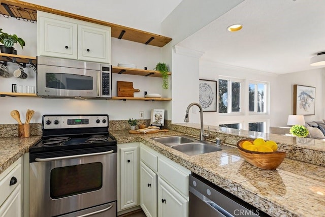 20371 Bluffside Cir Unit B401, Huntington Beach, CA 92646 - kitchen with open shelves, tile counters, stainless steel appliances, and a sink
