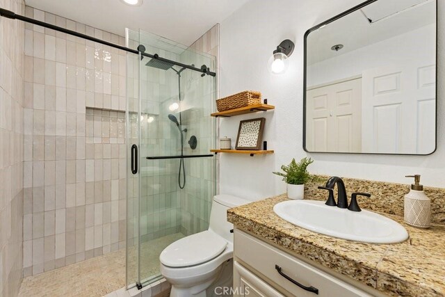 20371 Bluffside Cir Unit B401, Huntington Beach, CA 92646 - bathroom with toilet, vanity, and a stall shower