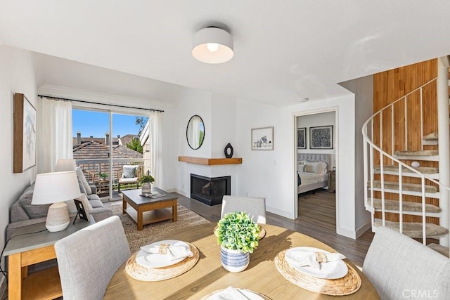 20371 Bluffside Cir Unit B401, Huntington Beach, CA 92646 - dining space featuring a fireplace, stairway, baseboards, and wood finished floors