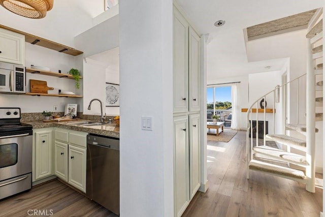 20371 Bluffside Cir Unit B401, Huntington Beach, CA 92646 - kitchen featuring open shelves, wood finished floors, stainless steel appliances, and a sink