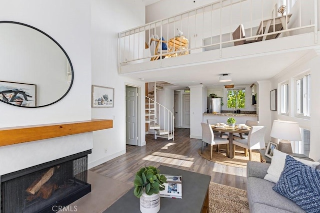 20371 Bluffside Cir Unit B401, Huntington Beach, CA 92646 - living room featuring stairway, a high ceiling, and wood finished floors
