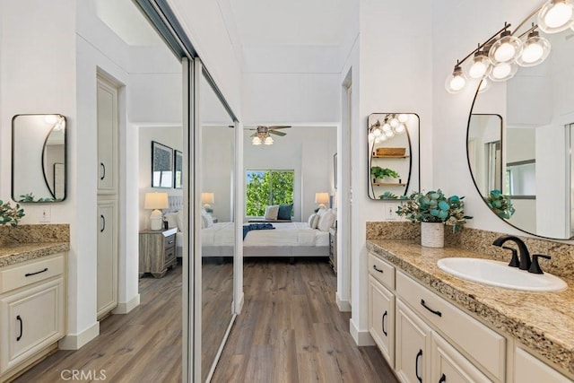 20371 Bluffside Cir Unit B401, Huntington Beach, CA 92646 - ensuite bathroom featuring wood finished floors, a sink, ceiling fan, and connected bathroom