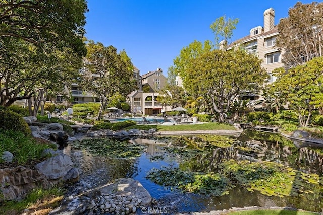 20371 Bluffside Cir Unit B401, Huntington Beach, CA 92646 - view of home's community with a swimming pool and a small pond