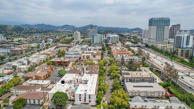 birds eye view of property featuring a mountain view and a city view