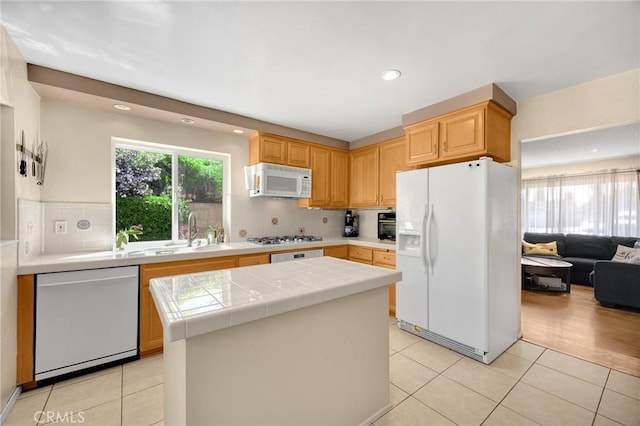 17381 Yorkshire Ave, Yorba Linda, CA 92886 - kitchen featuring white appliances, light tile patterned floors, tile counters, a kitchen island, and a sink