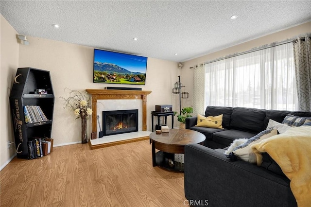 17381 Yorkshire Ave, Yorba Linda, CA 92886 - living area with recessed lighting, wood finished floors, a fireplace, baseboards, and a textured ceiling