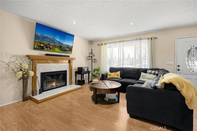 17381 Yorkshire Ave, Yorba Linda, CA 92886 - living room with a high end fireplace, recessed lighting, a textured ceiling, and wood finished floors