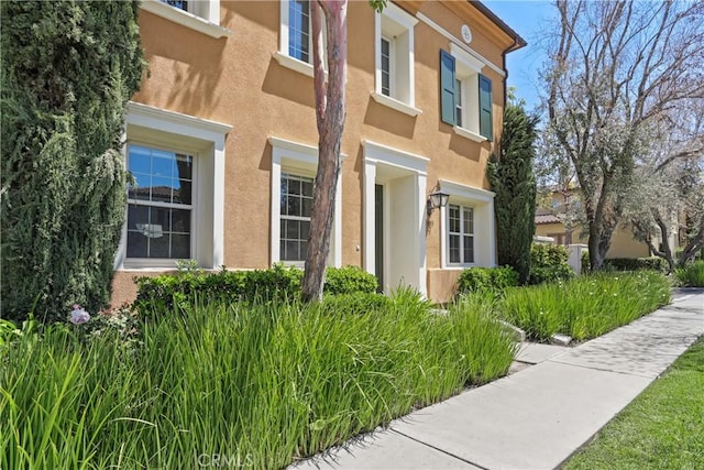 view of side of property with stucco siding
