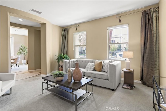living room featuring baseboards, visible vents, light colored carpet, and recessed lighting