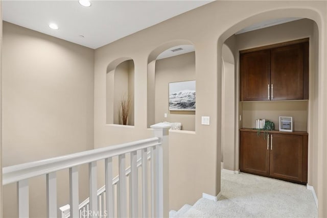 hallway featuring recessed lighting, an upstairs landing, visible vents, carpet, and baseboards