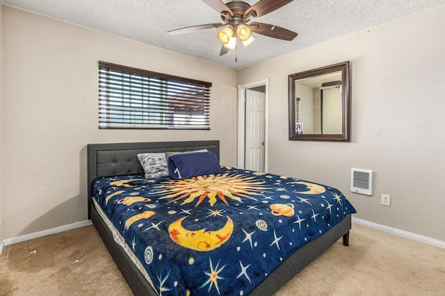bedroom featuring baseboards, a textured ceiling, and carpet