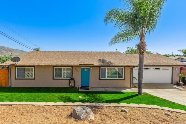 ranch-style home with a front lawn, an attached garage, concrete driveway, and stucco siding