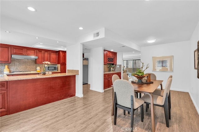 dining area with recessed lighting, baseboards, visible vents, and light wood-style flooring